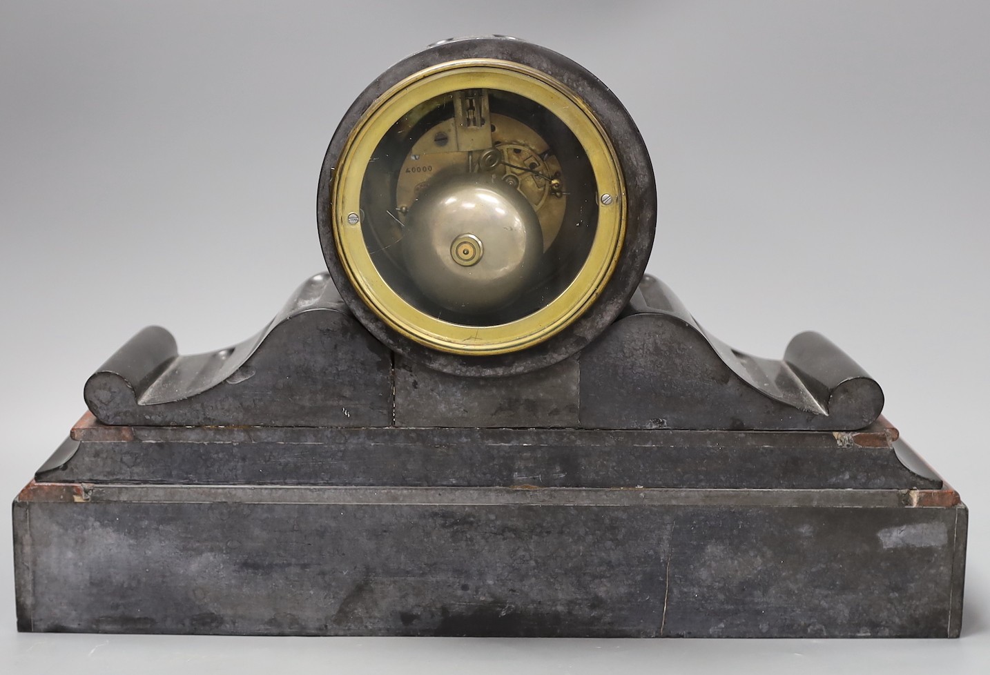 A French black slate and rouge marble mantel clock by Henry Marc, with key and pendulum, 28.5cm tall